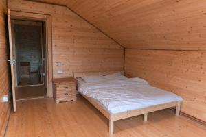 a bedroom with a bed in a wooden room at Cabana Ruth in Valea Ierii