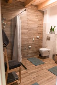 a bathroom with a shower and a toilet at Cabana Ruth in Valea Ierii