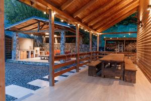 an outdoor patio with a wooden table and benches at Cabana Ruth in Valea Ierii