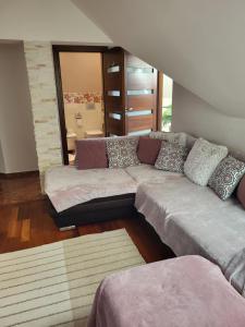 a living room with a large couch in a room at Radzymin Pd Faktura Invoice Fully equipped apartment with a private parking and garden in Radzymin
