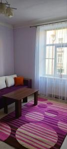 a living room with a couch and a table at 2х кімнатна квартира у Львові поряд з залізничним вокзалом in Lviv