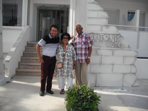 a group of three people standing in front of a building at Antonis Hotel in Kefalos