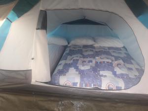 a small room with a bed in a tent at Kamp Seosko domaćinstvo Radman - Šator arpenaz 4 in Herceg-Novi