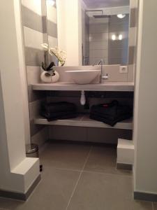 a bathroom with a sink and a mirror at Le Diodon De Sagone in Sagone