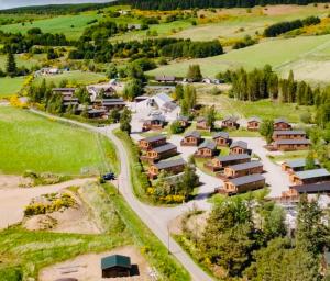 an aerial view of a village with houses at Clochnaben lodge, castle wood, strachan ab31 6NQ in Strachan