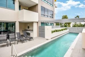 an image of a house with a swimming pool at Nova Apartments 104 Mooloolaba Beach in Mooloolaba