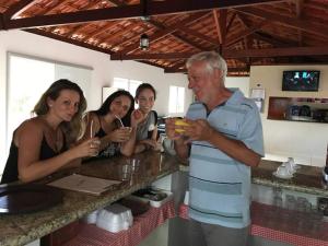 a man standing in a kitchen with a group of people at BANGALÕ DO LAGO in Caconde