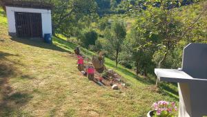 a couple of people standing in a yard with trees at Family house in Visoko +9 photos