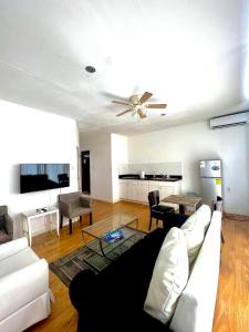 a living room with a couch and a ceiling fan at Dushi Apartments in Willemstad
