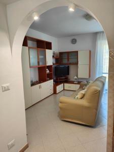 a living room with a couch and a tv at La Casa di Vandina in Senigallia +16 photos