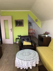 a living room with a couch and a table at Vila Kysuca in Luhačovice