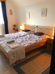 a bedroom with two beds and a table with a lamp at Vila Kysuca in Luhačovice