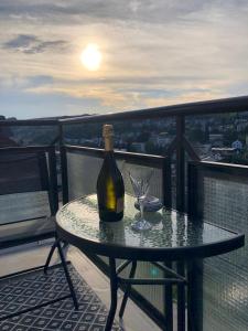 a bottle of wine sitting on a table on a balcony at Vila Kysuca in Luhačovice