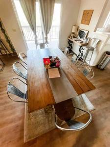 a large wooden table with chairs in a living room at Retreat Home Near Yosemite and Bass Lake! in Oakhurst