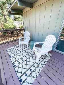 two white chairs sitting on the porch of a house at Retreat Home Near Yosemite and Bass Lake! in Oakhurst