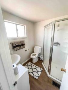 a bathroom with a shower and a toilet and a sink at Retreat Home Near Yosemite and Bass Lake! in Oakhurst