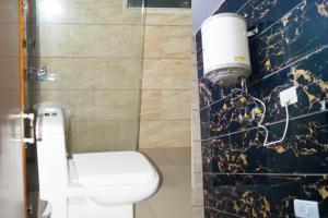 łazienka z białą toaletą i ścianą w obiekcie Hotel Maharaja Continental - New Delhi w Nowym Delhi