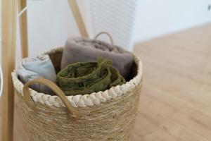 a basket filled with towels on a floor at Centra apartamenti in Liepāja