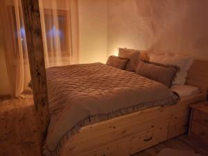 a bed with a wooden frame in a bedroom at Naturoase in Inzigkofen