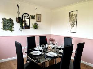 a dining room with a black table and chairs at Lake view Pet Friendly parking golf nearby in Bowness-on-Windermere +27 photos