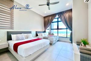 a bedroom with two beds and a large window at Atlantis Melaka I 5-11pax I 5min JonkerSt By Alviv Management in Malacca