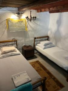 two twin beds in a room with a wall at Holiday home Stiniva in Vis
