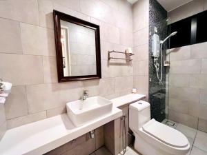 a bathroom with a sink and a toilet and a mirror at THE SHORE KOTA KINABALU - SABAKUBA HOMESTAY (B2010) in Kota Kinabalu