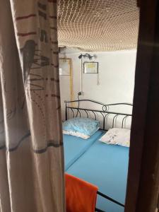 a bedroom with a bed with blue sheets at Holiday home Stiniva in Vis