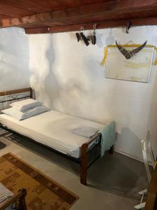 a small bed in a room with a wall at Holiday home Stiniva in Vis