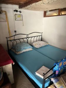 a bedroom with a blue bed in a room at Holiday home Stiniva in Vis