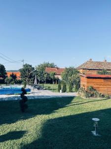 a view of a yard with a pool and a building at Sobe Djurdjevic in Zatonje