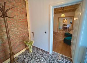 a living room with a brick wall and a hallway at Victoria Gasthaus Rasnov - charming vacation house in Rasnov in Râşnov