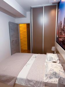a bedroom with a large bed and a tv at Dono apartment in Skopje