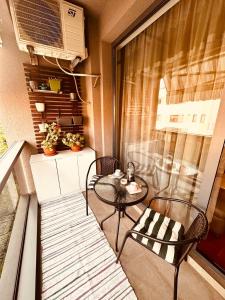 a balcony with a table and chairs and a window at Dono apartment in Skopje