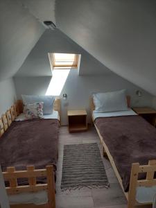 a attic room with two beds and a skylight at Casa Anne in Mangalia