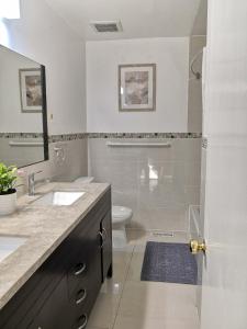 a bathroom with a shower and a sink and a toilet at spacious and bright house in Toronto