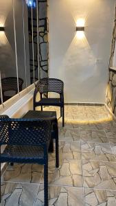 patio z 2 krzesłami i stołem na kamiennej podłodze w obiekcie Stone house apart hotel w mieście Arnavutköy