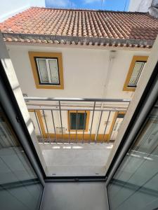 a view from the ceiling of a building with a balcony at Apartamento Familia Silva in Nazaré