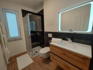 a bathroom with a sink and a shower and a toilet at Ferienwohnungen am Wasserfall in Bad Urach +31 photos