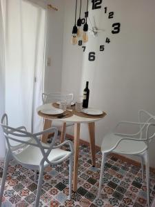 una mesa con 2 sillas y una botella de vino en Departamentos Ines 2 en Junín