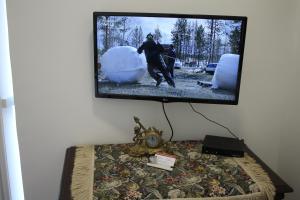 a flat screen tv hanging on a wall at Castellum Apartman in Keszthely