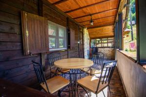 a porch with a table and chairs in a cabin at Vila Sara in Bajina Bašta
