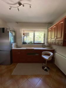 a kitchen with a refrigerator and a stool in it at Przystań u Bieszczadnika in Lutowiska +24 photos