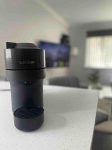 a black coffee cup sitting on a table at Newly Refurbished Apartment with private parking in Southampton