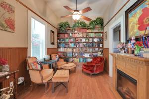 a living room with a fireplace and book shelves at Spacious Downtown Jackson Retreat- Historic Hangout in Jackson