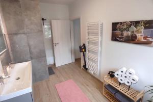 a bathroom with a sink and a toilet and a shower at Storchennest - Ferienwohnung am Storchenradweg in Ketzür +29 photos