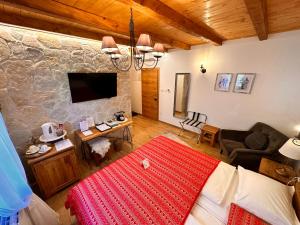 a living room with a bed and a couch and a tv at Boutique Villa Pearl of Plitvice, Plitvice Lakes in Plitvica selo