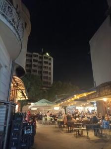 een groep mensen die 's nachts aan tafel zitten bij Maria's Place in Bitola