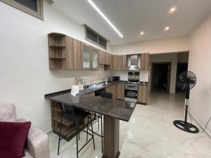 a kitchen with a large island in a room at Jasmine flower hostel in Madaba