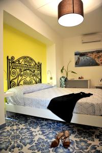 a bedroom with a bed with shoes on the floor at Il Leone Di Mare in Procida